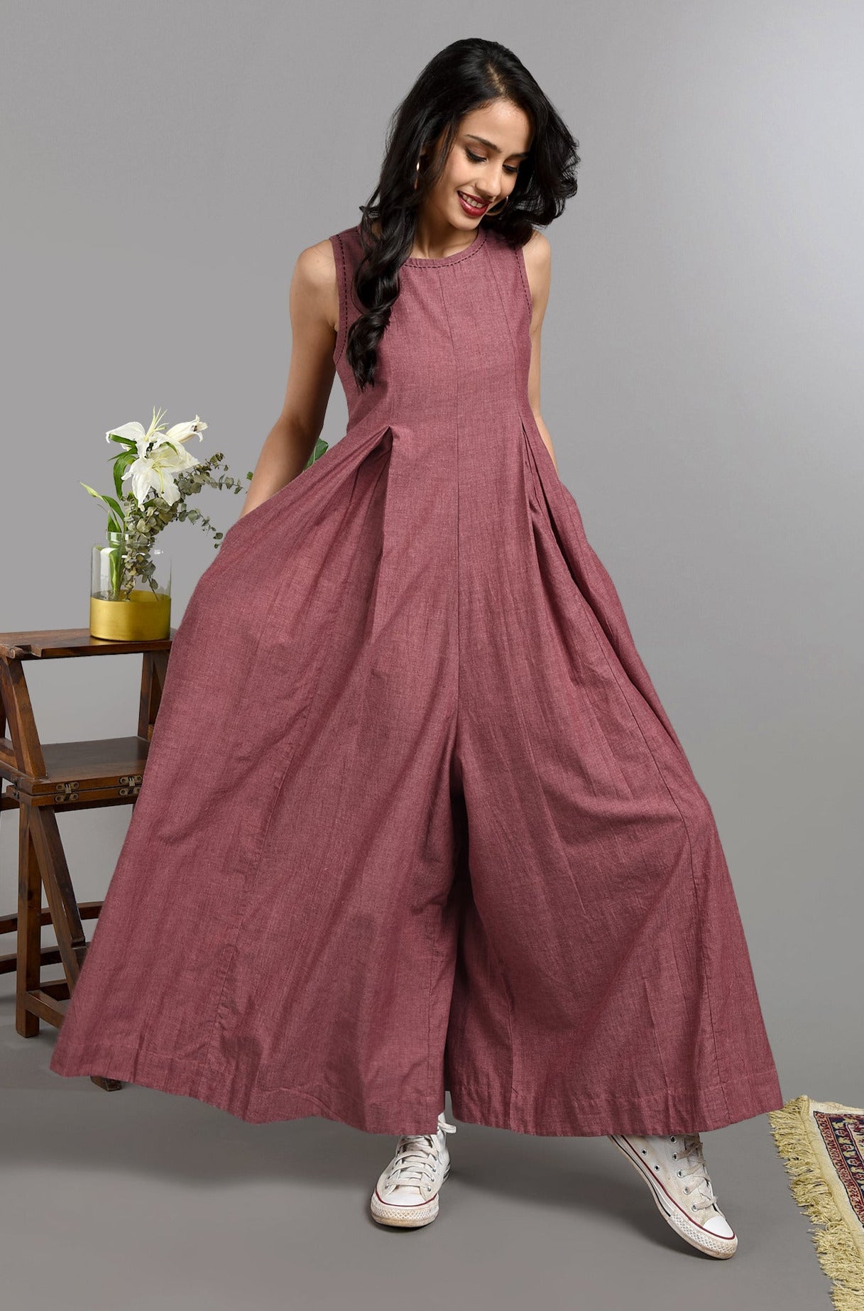 Long ankle length sleeveless jumpsuit in subtle buff pink with back zipper and box pleat and pockets