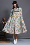 Vintage swirl flare dress in white delicate floral print with high bust yoke and gathers with green printed trims