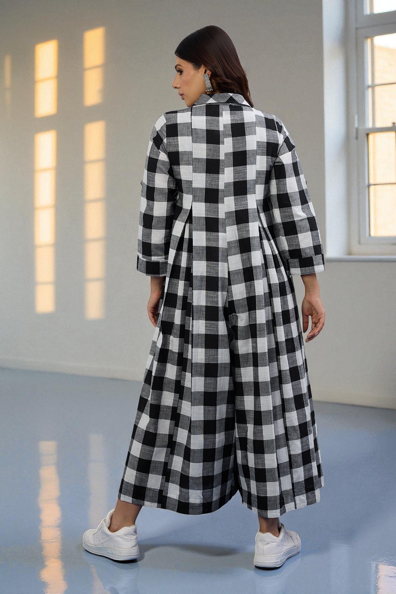 Woman wearing a black and white checkered jumpsuit