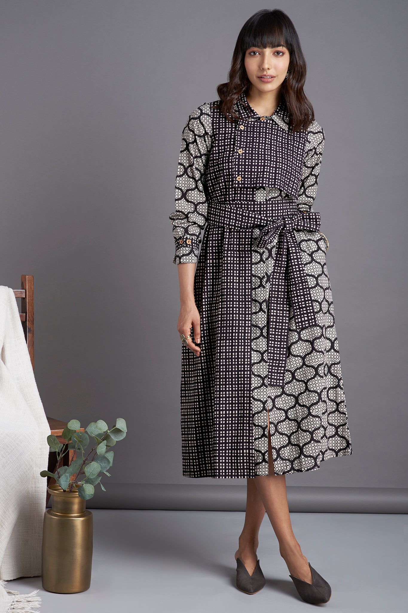 Black mosaic print Knee length dress with collar in black white checks and front flap with buttons and belt  and side pockets 