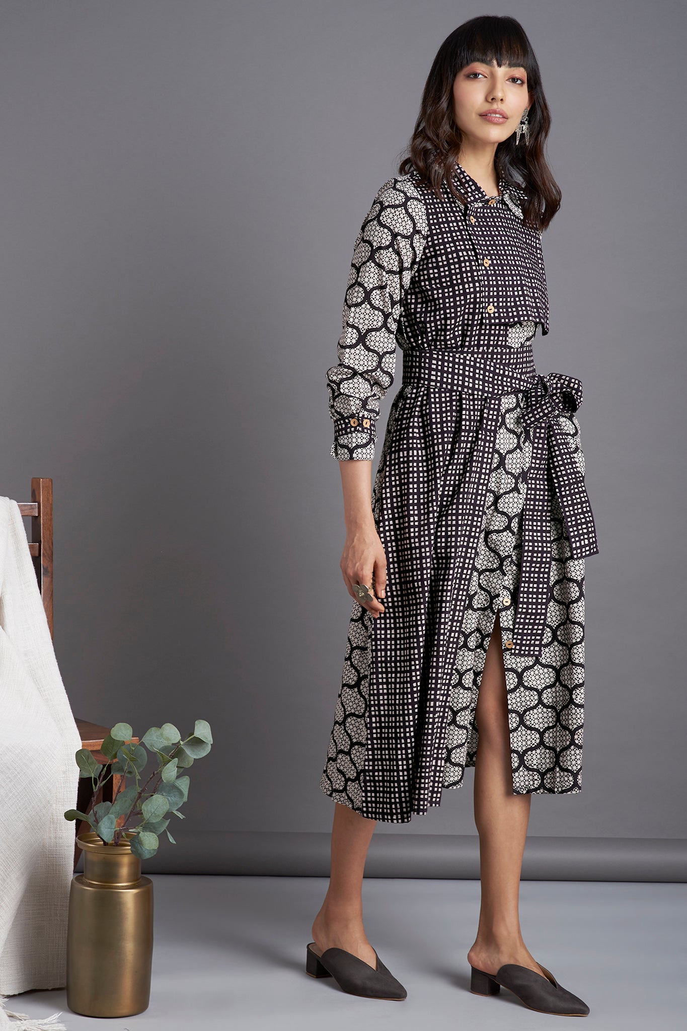 Black mosaic print Knee length dress with collar in black white checks and front flap with buttons and belt  and side pockets 