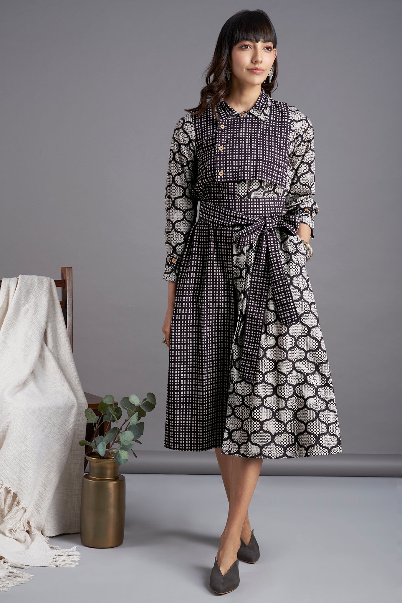 Black Bagh mosaic print Knee length dress with collar in black white checks and front flap with buttons and belt  and side pockets 