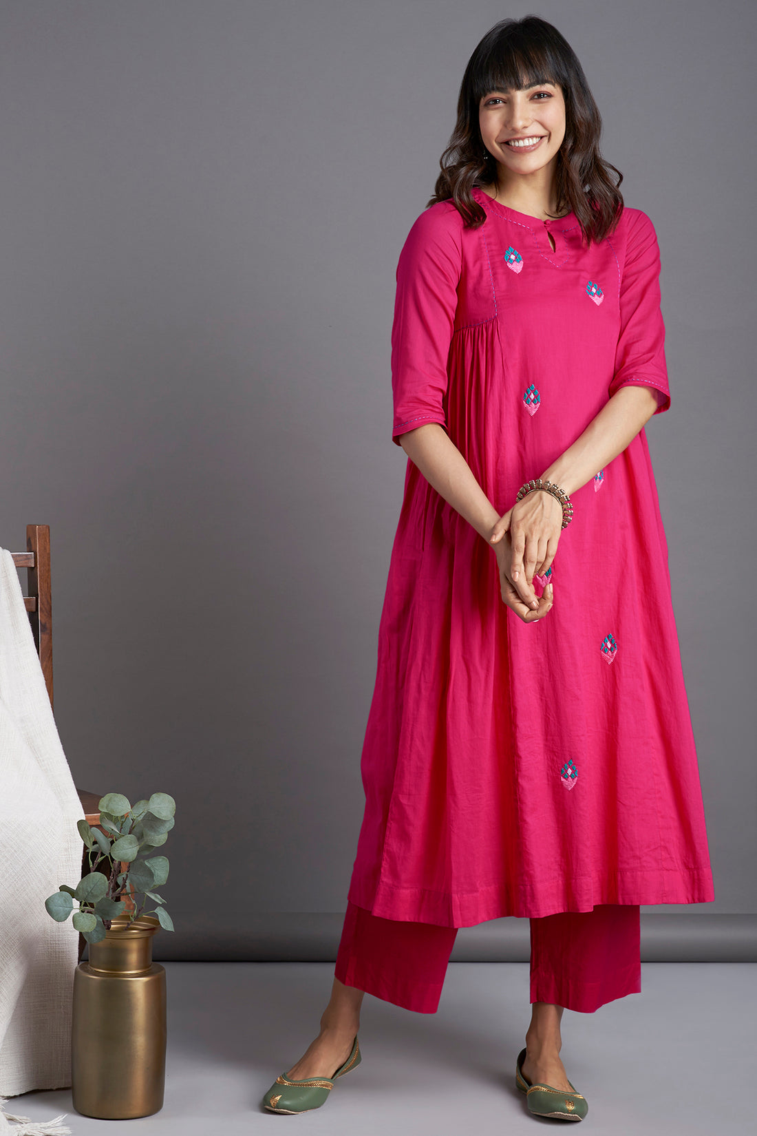 Rani pink mul cotton gather kurta with lining and pockets with delicate tulip hand embroidery in green and peach and with coordinated pants