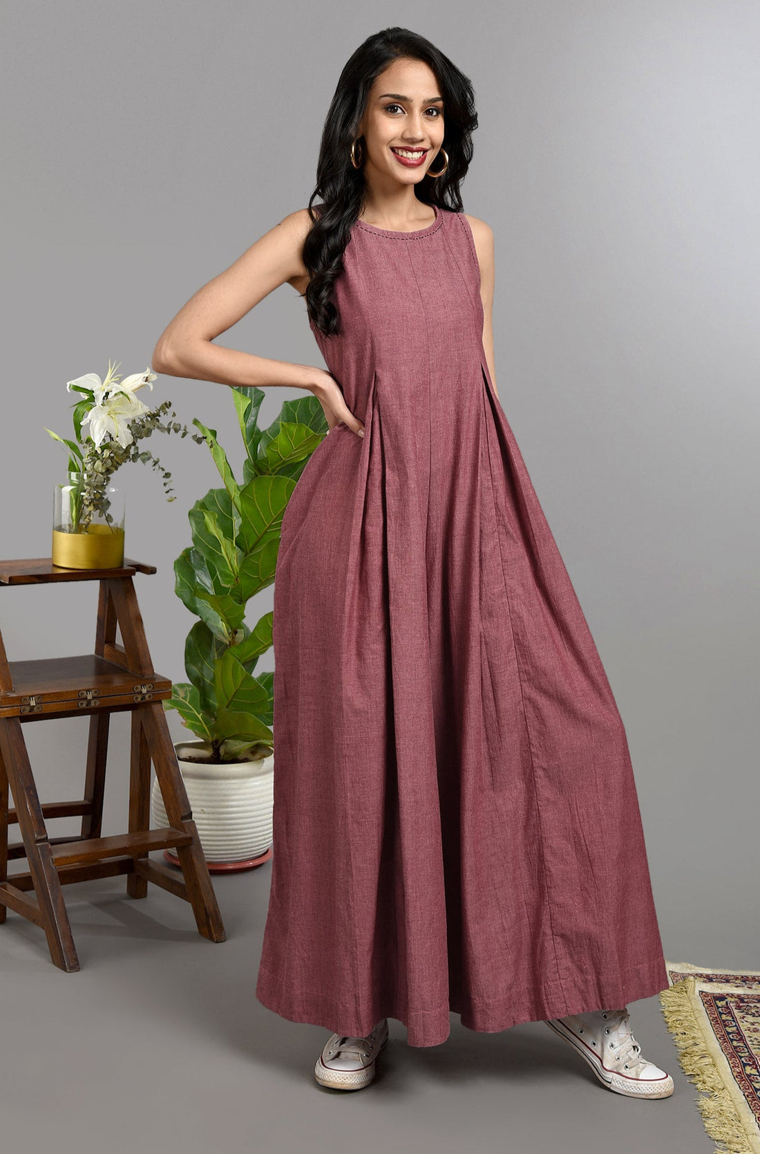 Long ankle length sleeveless jumpsuit in subtle buff pink with back zipper and box pleat and pockets